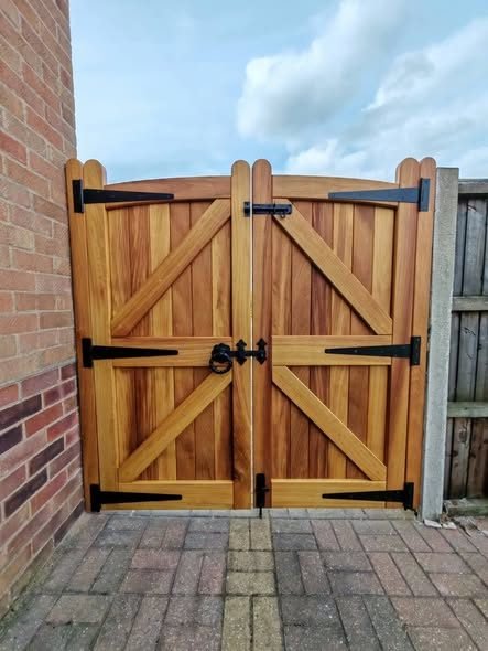 A pair of hardwood garden gates with black ironmongery
